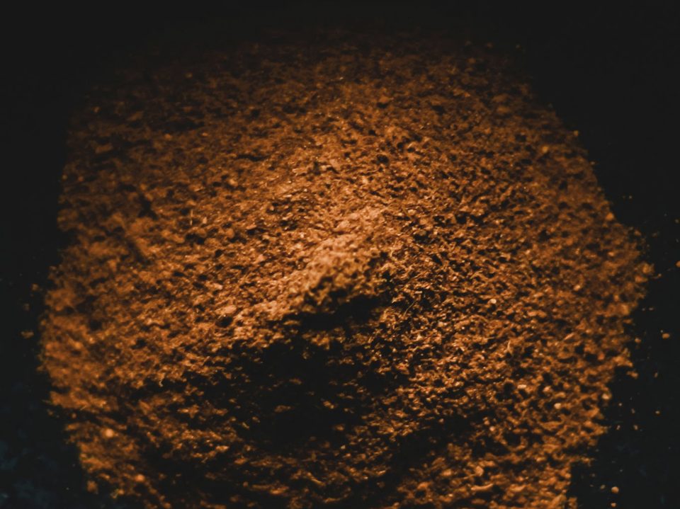 Jamun seed extract, a light to mid brown fine powder in a dark bowl