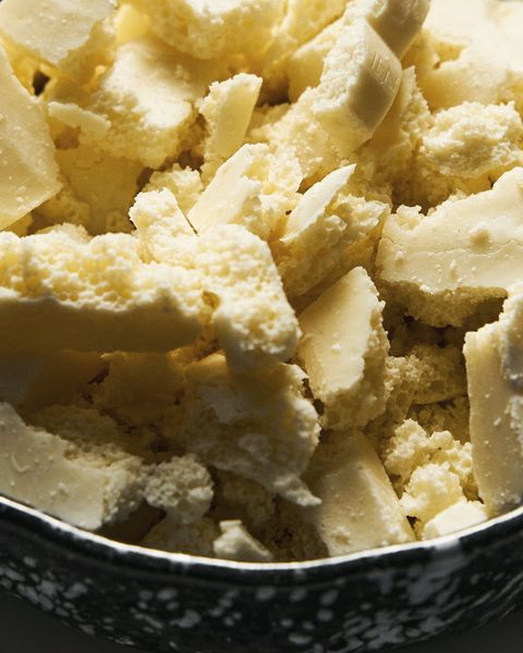 Pieces of kokum butter in a speckled bowl